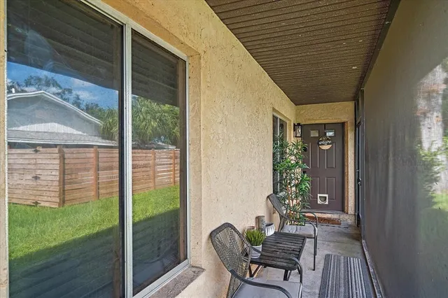 a porch with a table and chairs