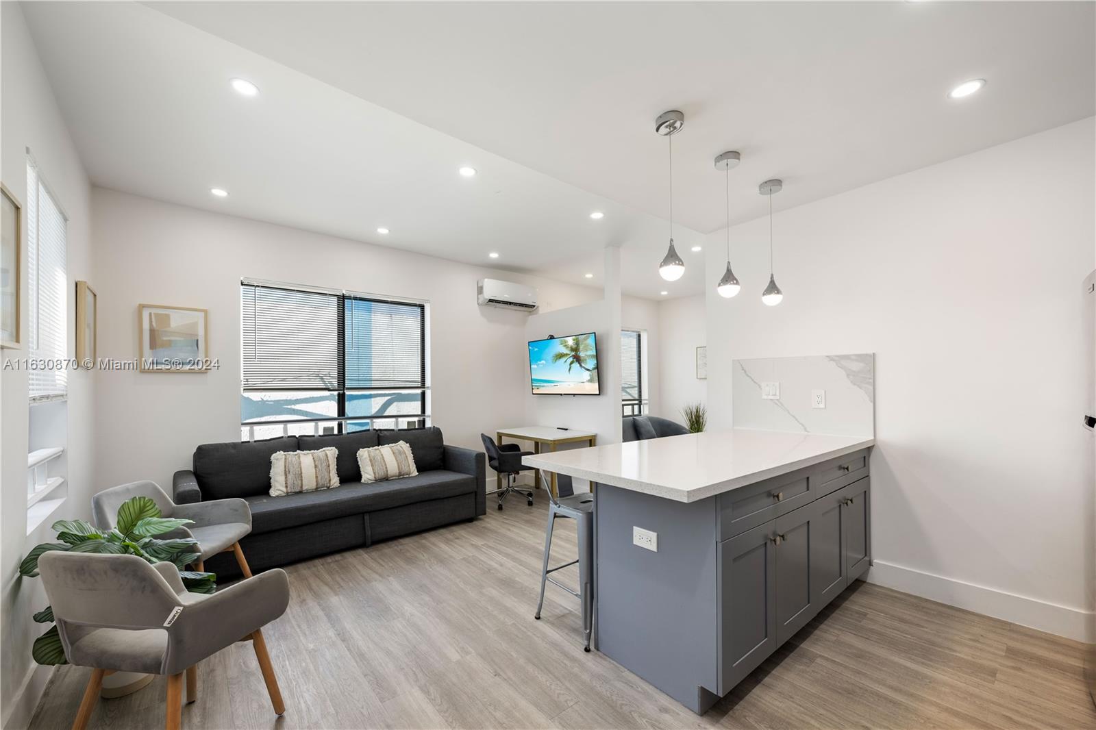 1648 Southwest 7th Street Miami, FL 33135 - Photo 13 of 23 a living room with kitchen island furniture and a wooden floor