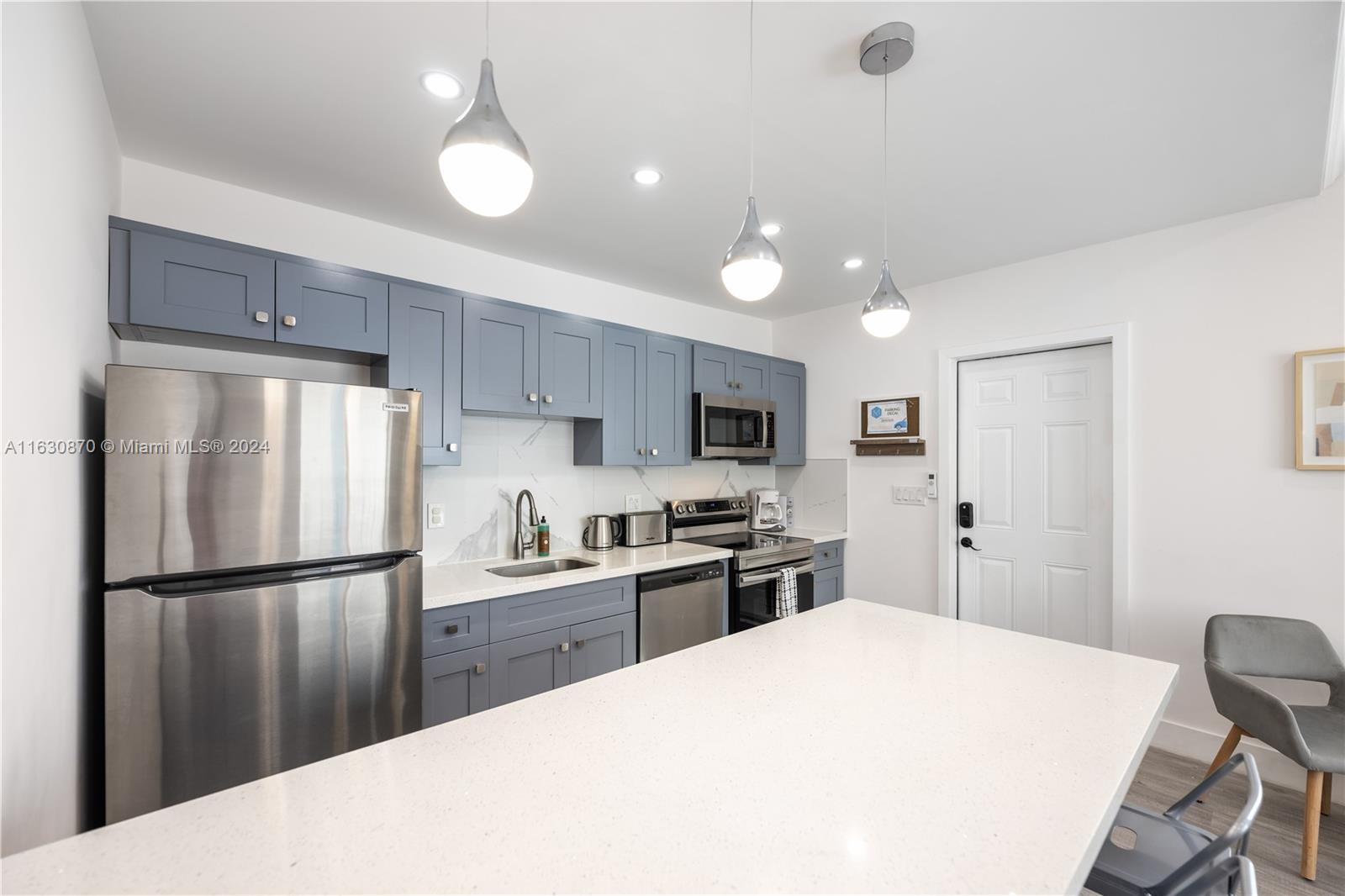 1648 Southwest 7th Street Miami, FL 33135 - Photo 17 of 23 a kitchen with stainless steel appliances granite countertop a refrigerator sink and cabinets