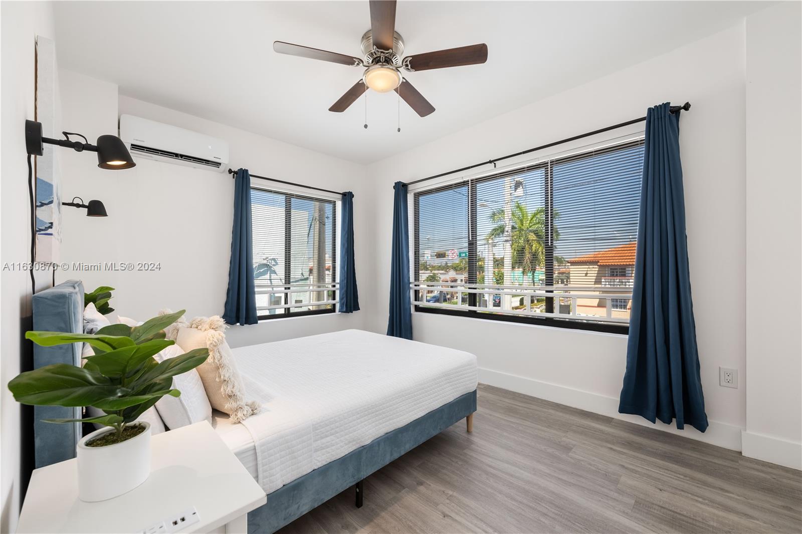 1648 Southwest 7th Street Miami, FL 33135 - Photo 21 of 23 a spacious bedroom with a balcony a bed and a chandelier
