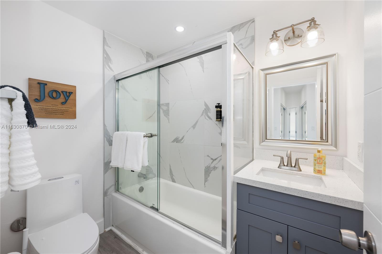 1648 Southwest 7th Street Miami, FL 33135 - Photo 23 of 23 a bathroom with a granite countertop sink toilet and shower