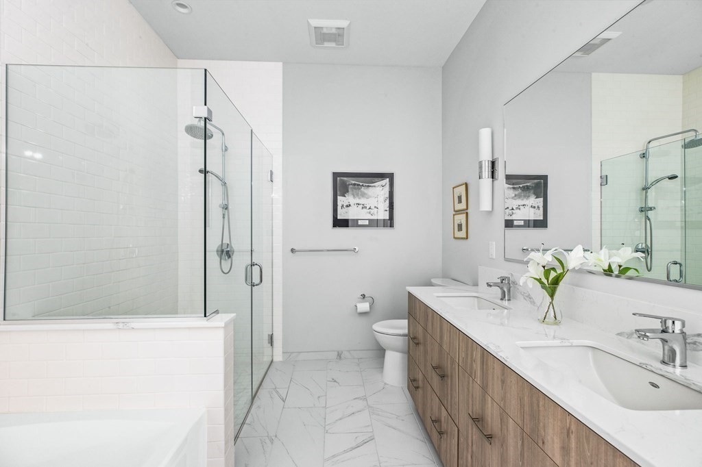 10 Shipyard Drive, Unit 408 Hingham, MA 02043 - Photo 13 of 26 a bathroom with a double vanity sink mirror double and shower