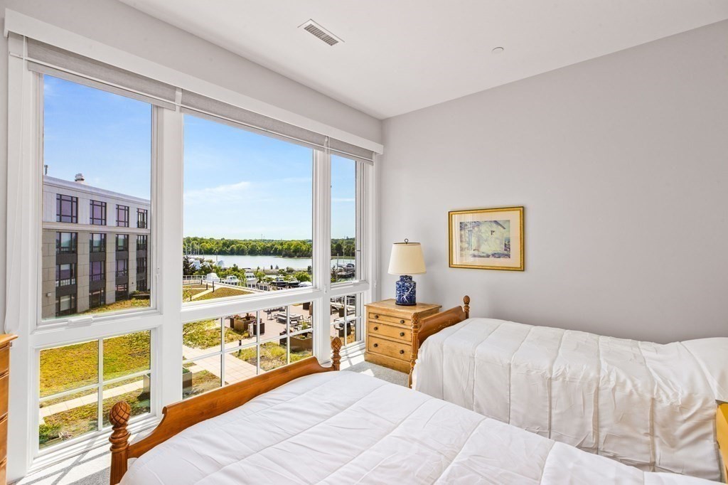 10 Shipyard Drive, Unit 408 Hingham, MA 02043 - Photo 15 of 26 a bedroom with a large bed and a large window