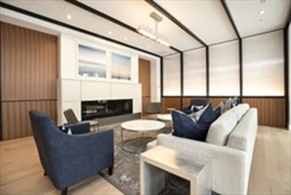 10 Shipyard Drive, Unit 408 Hingham, MA 02043 - Photo 22 of 26 a living room with furniture a fireplace and a large window