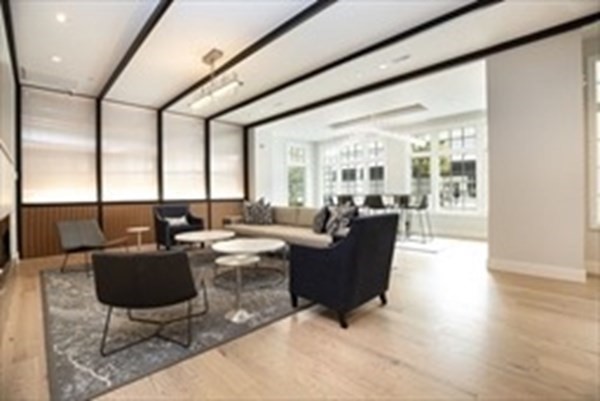 10 Shipyard Drive, Unit 408 Hingham, MA 02043 - Photo 24 of 26 a living room with furniture potted plant and a large window