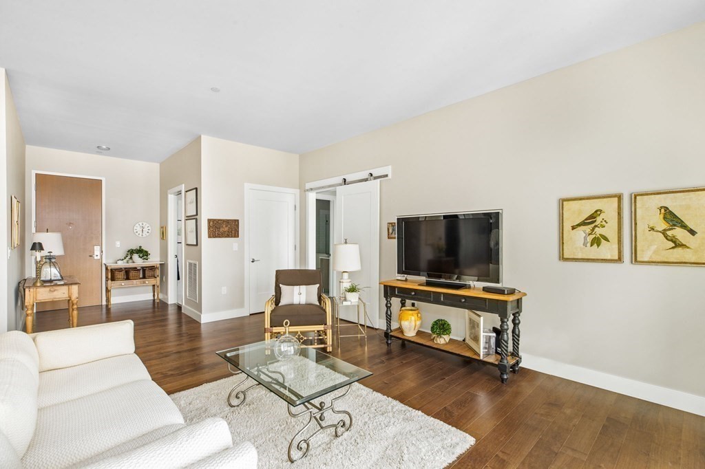 10 Shipyard Drive, Unit 408 Hingham, MA 02043 - Photo 3 of 26 a living room with furniture and a flat screen tv