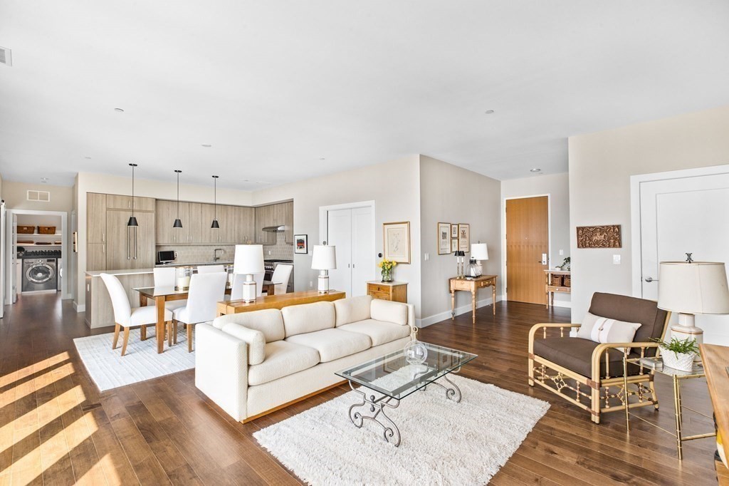 10 Shipyard Drive, Unit 408 Hingham, MA 02043 - Photo 9 of 26 a living room with furniture and a dining table with wooden floor
