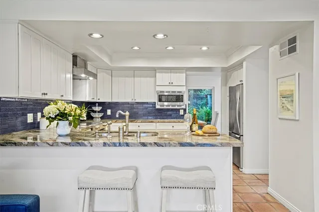 a living room with furniture and kitchen view