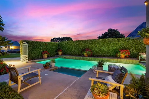 a view of a patio with couches and table and chairs and potted plants