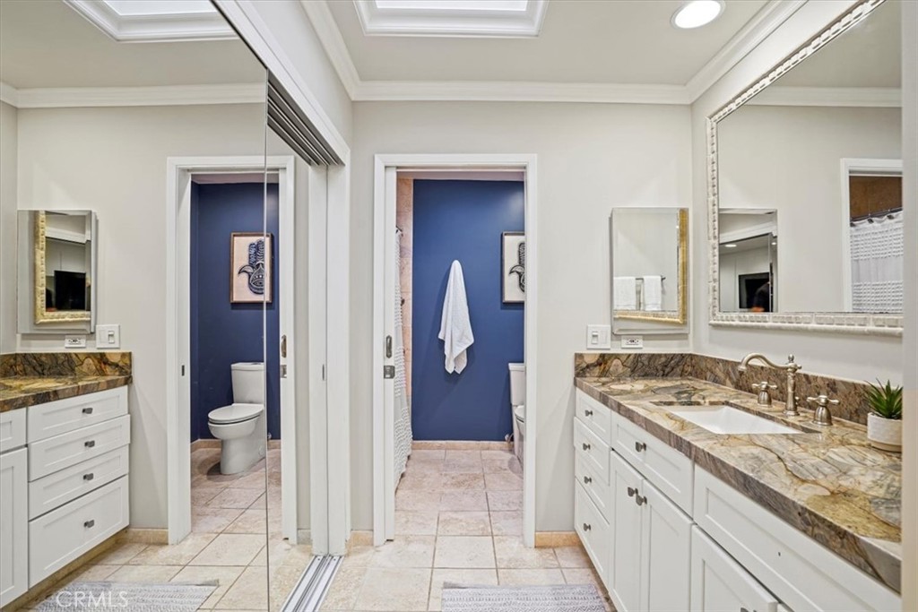 23802 Cassandra Bay Dana Point, CA 92629 - Photo 33 of 56 a spacious bathroom with a granite countertop sink and a mirror