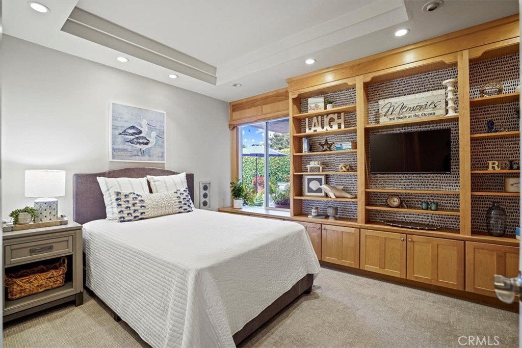 23802 Cassandra Bay Dana Point, CA 92629 - Photo 36 of 56 a spacious bedroom with a bed and a flat screen tv