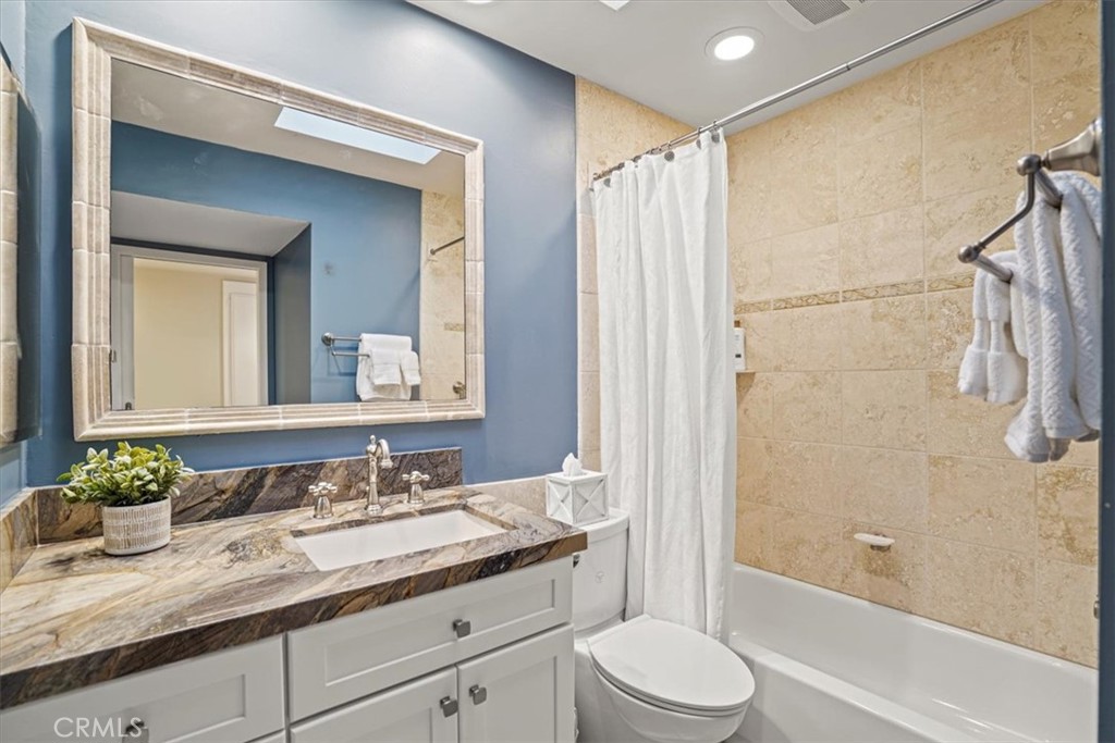 23802 Cassandra Bay Dana Point, CA 92629 - Photo 40 of 56 a bathroom with a granite countertop sink toilet and shower