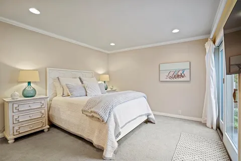 a small pool with table and chairs under an umbrella