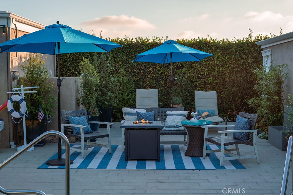 23802 Cassandra Bay Dana Point, CA 92629 - Photo 49 of 56 a view of a rooftop deck with table and chairs under an umbrella