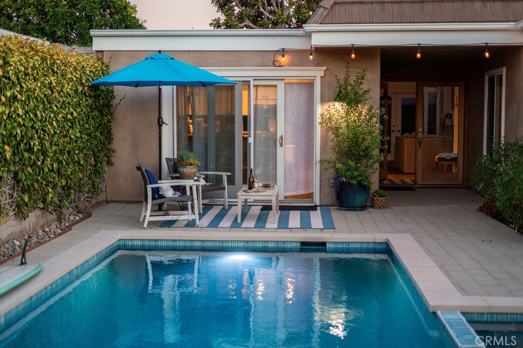 23802 Cassandra Bay Dana Point, CA 92629 - Photo 51 of 56 a small pool with table and chairs under an umbrella