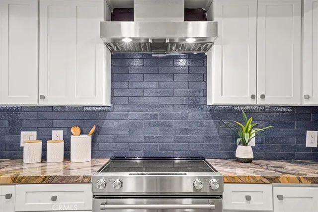a kitchen with a stove top oven and cabinets