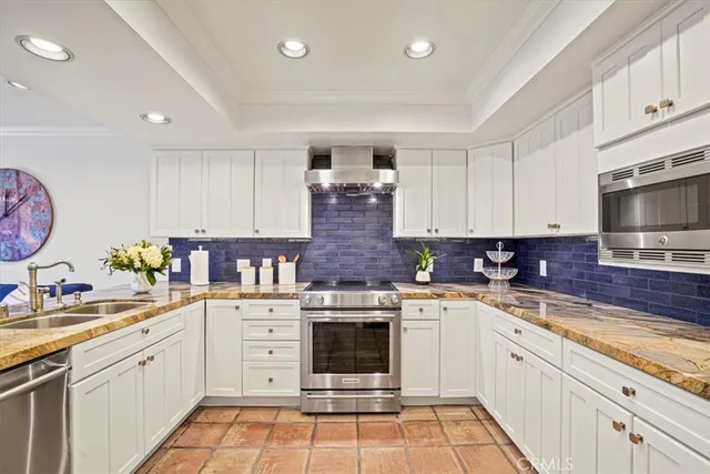 a kitchen with kitchen island granite countertop a sink cabinets and counter space
