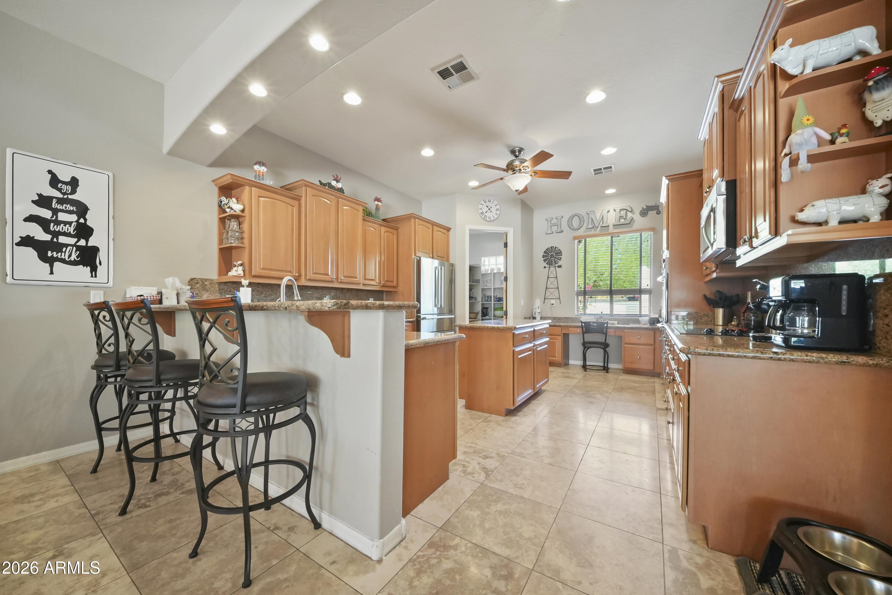 605 West Ridgecrest Road Phoenix, AZ 85086 - Photo 18 of 40 a dining hall with stainless steel appliances a dining table and chairs
