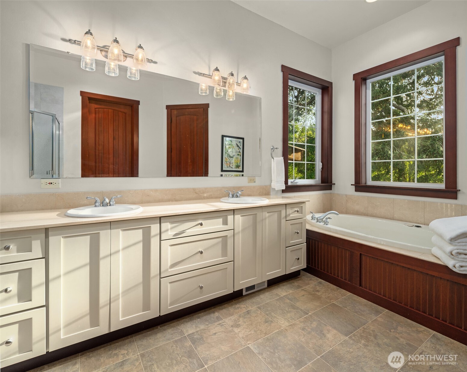 1000 Creso Road South Spanaway, WA 98387 - Photo 15 of 40 a bathroom with a granite countertop double vanity sink a large mirror a bathtub and a window