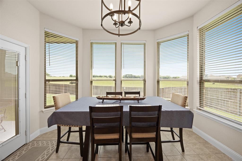 2618 Byrd Ranch Road Midlothian, TX 76065 - Photo 21 of 38 a view of a dining room with furniture large windows and wooden floor