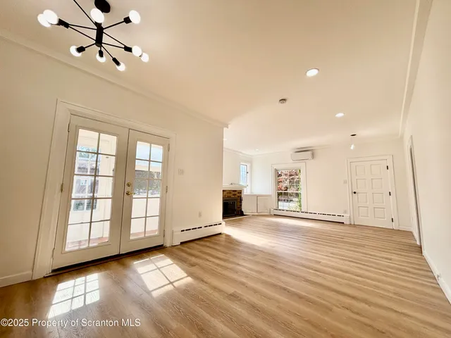 a view of a livingroom with a ceiling fan and window