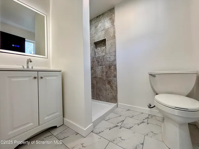 a bathroom with a toilet sink and shower