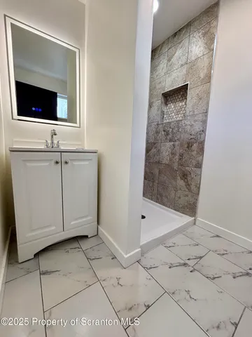 a view of a bathroom with a sink and a mirror