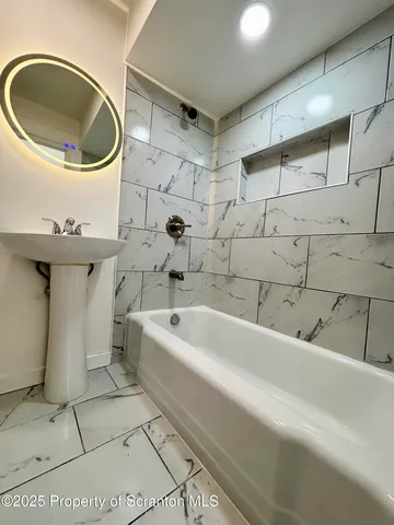 a bathroom with a bathtub sink and toilet