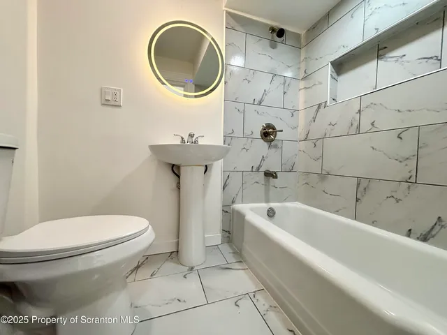 a bathroom with a toilet and a sink