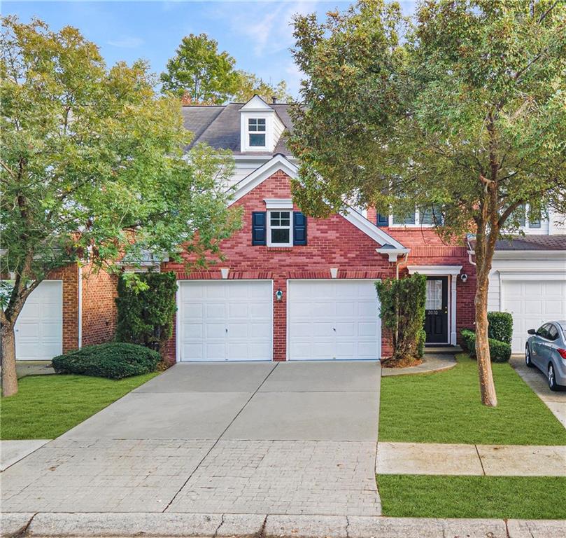 2070 Hailston Drive Northwest Duluth, GA 30097 - Photo 1 of 42 a front view of a house with a garden and trees