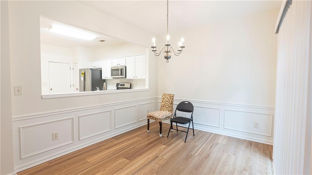 2070 Hailston Drive Northwest Duluth, GA 30097 - Photo 13 of 42 a view of a bedroom with furniture wooden floor and a ceiling fan