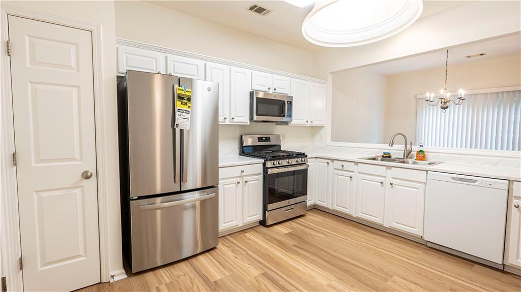 2070 Hailston Drive Northwest Duluth, GA 30097 - Photo 15 of 42 a kitchen with a refrigerator stove and sink