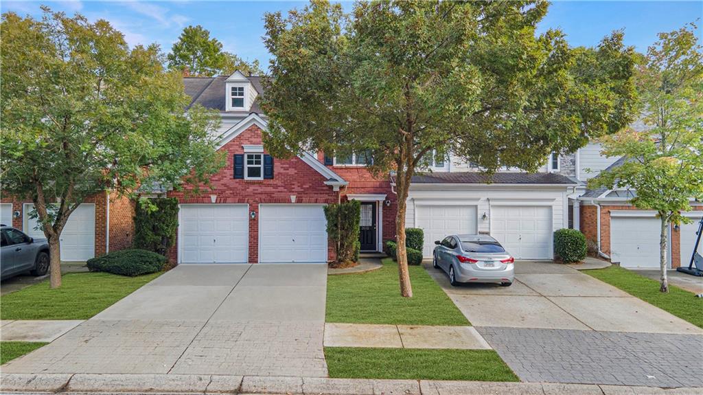 2070 Hailston Drive Northwest Duluth, GA 30097 - Photo 2 of 42 a front view of a house with a garden and trees