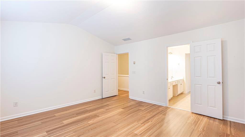 2070 Hailston Drive Northwest Duluth, GA 30097 - Photo 21 of 42 a view of an empty room with wooden floor