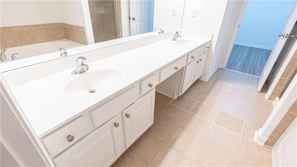 2070 Hailston Drive Northwest Duluth, GA 30097 - Photo 23 of 42 a spacious bathroom with double vanity and mirrors