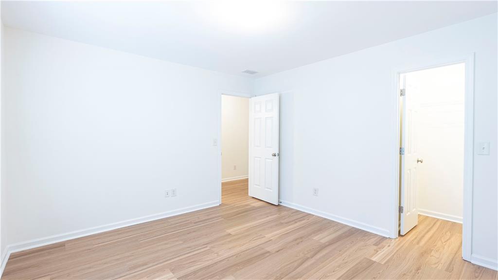 2070 Hailston Drive Northwest Duluth, GA 30097 - Photo 28 of 42 a view of an empty room with wooden floor