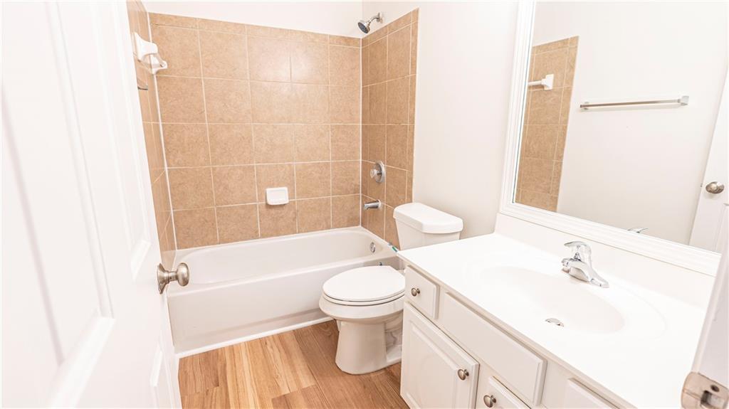 2070 Hailston Drive Northwest Duluth, GA 30097 - Photo 29 of 42 a bathroom with a sink a toilet and shower