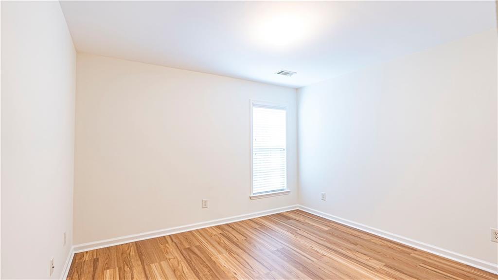 2070 Hailston Drive Northwest Duluth, GA 30097 - Photo 31 of 42 a view of an empty room with wooden floor and a window