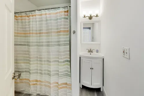a bathroom with a shower curtain and a sink