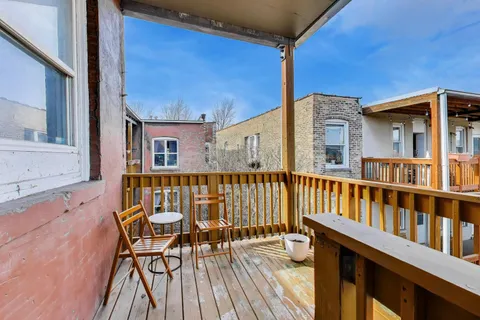 a view of a balcony with chairs