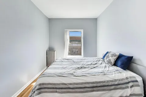 a bedroom with a bed and window