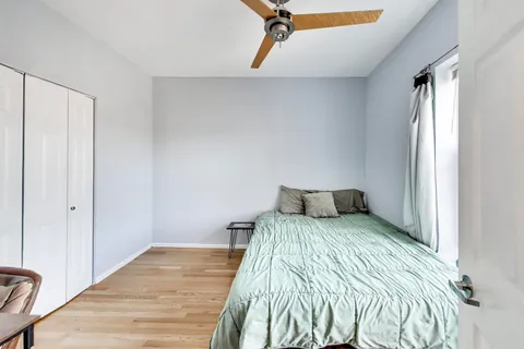 a bedroom with a bed and a window