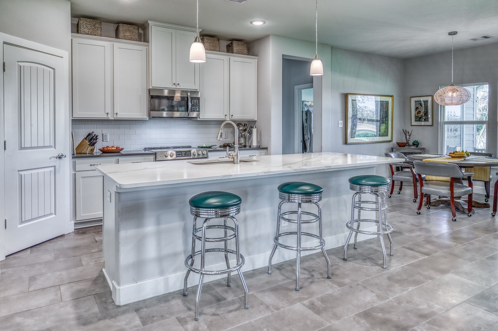 6510 Ganske Road Burton, TX 77835 - Photo 8 of 48 a kitchen with stainless steel appliances granite countertop a table chairs sink and cabinets