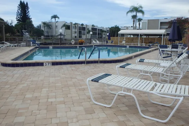 a view of a swimming pool with a table and chairs