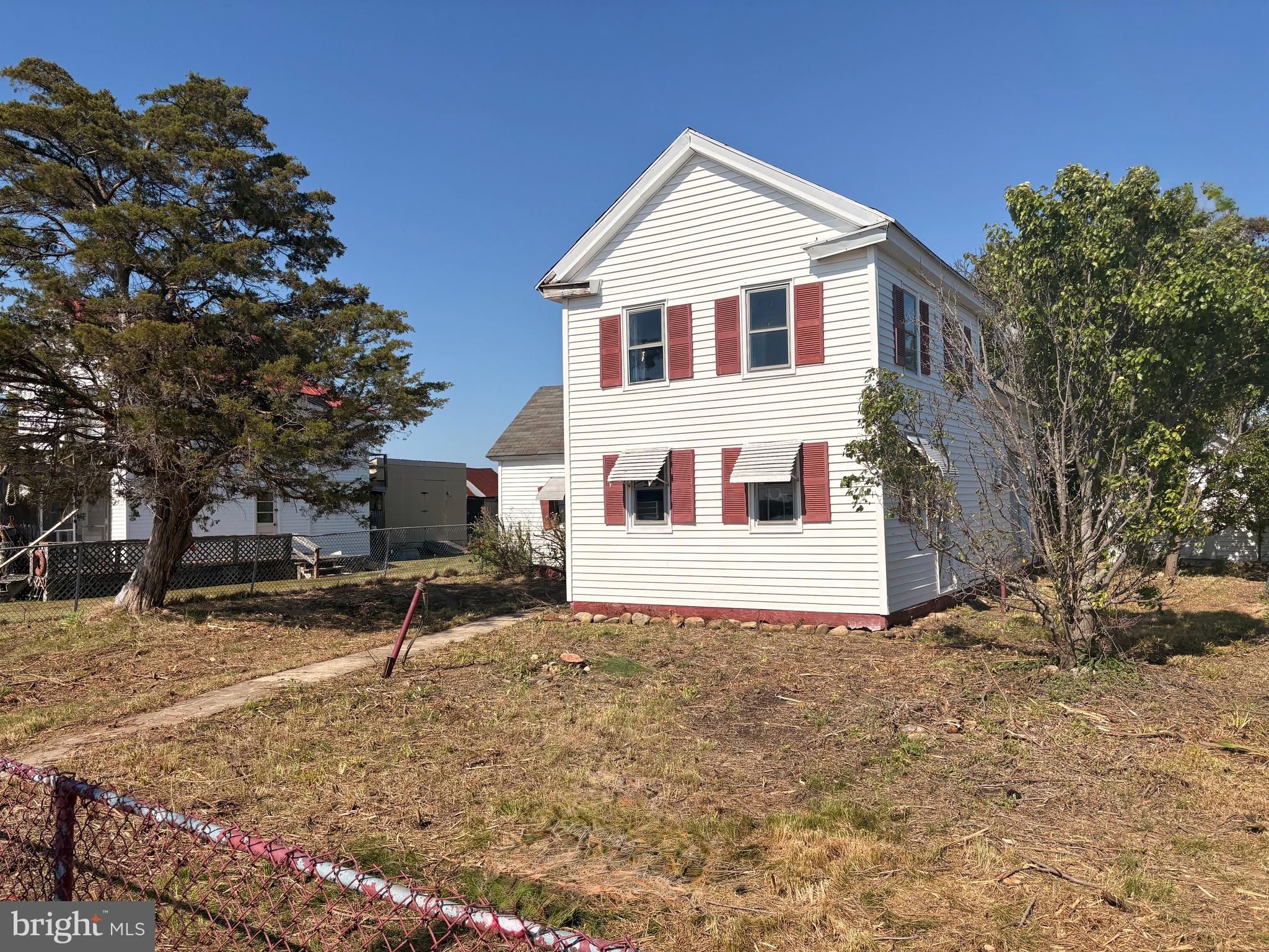 3251 Marsh Road Ewell, MD 21824 - Photo 31 of 32 a view of a white house with a yard