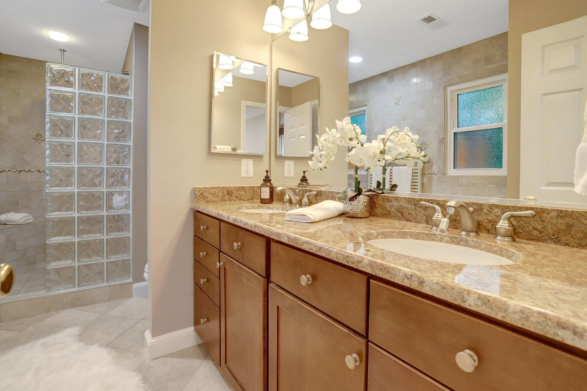 7506 Oriole Avenue Springfield, VA 22150 - Photo 21 of 67 a bathroom with a granite countertop sink and a mirror