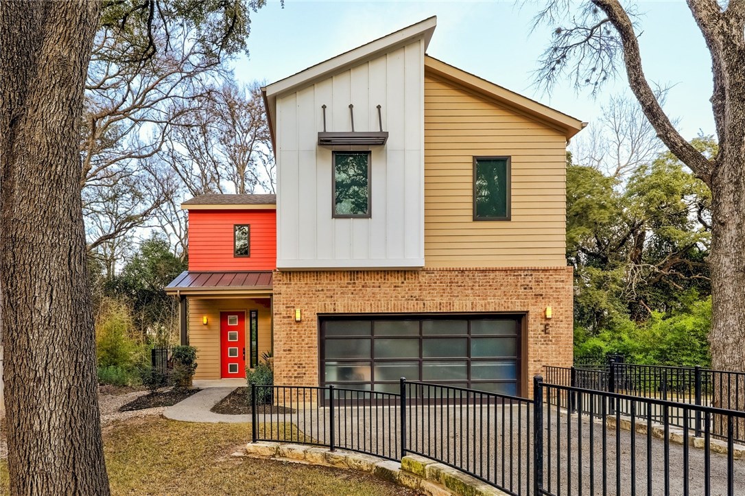 a front view of a house with entrance gate