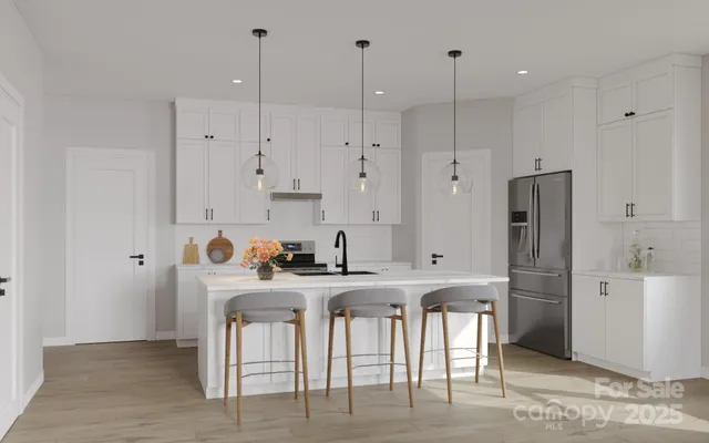 a kitchen with stainless steel appliances granite countertop a refrigerator a sink and a stove