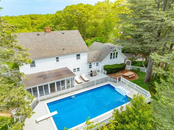 a aerial view of a house with pool and deck