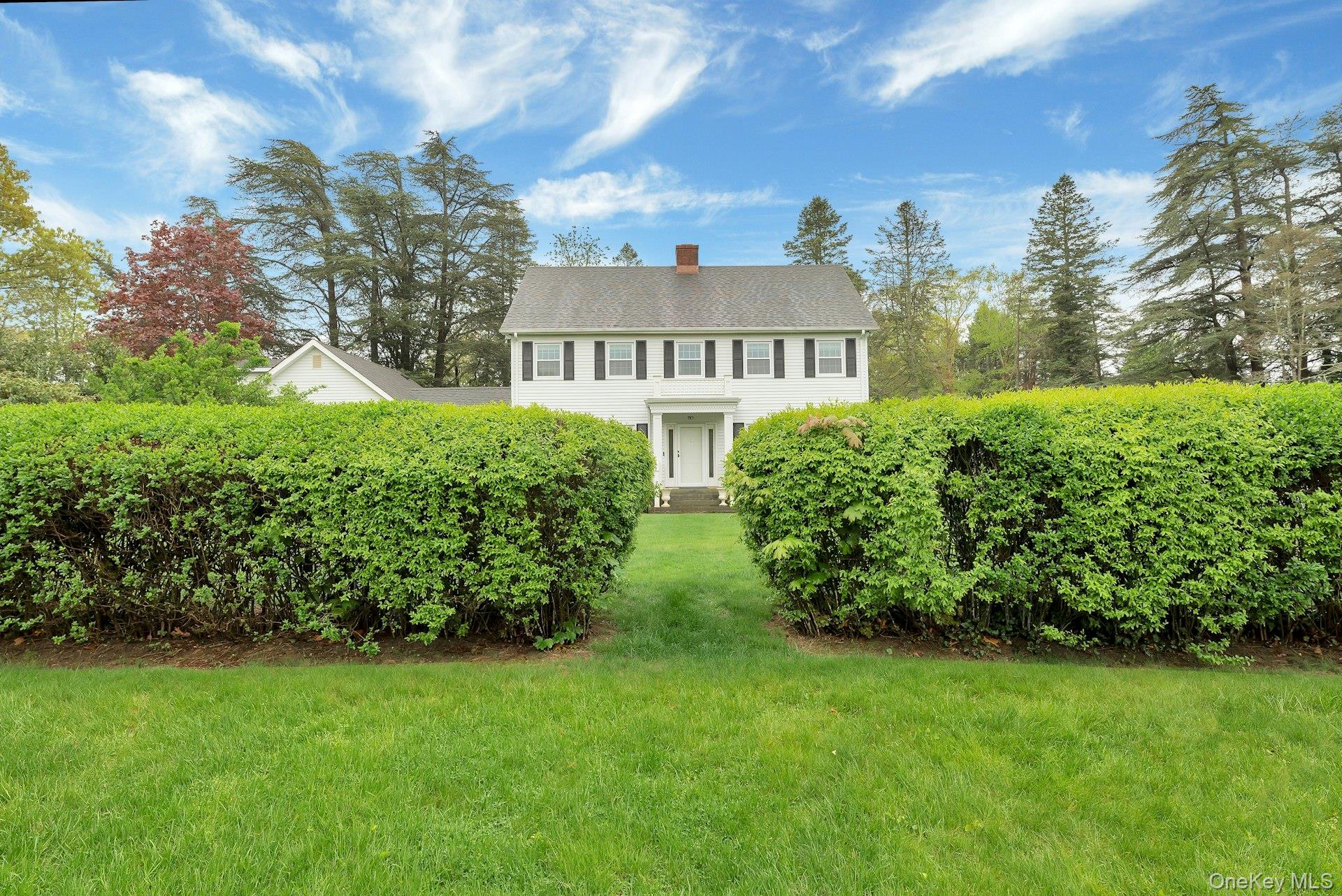 110 Sleepy Hollow Lane Southold, NY 11971 - Photo 39 of 46 Colonial home featuring a front yard and a chimney